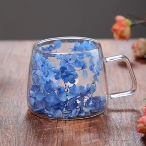 A stunning double-walled glass mug filled with  floral accents